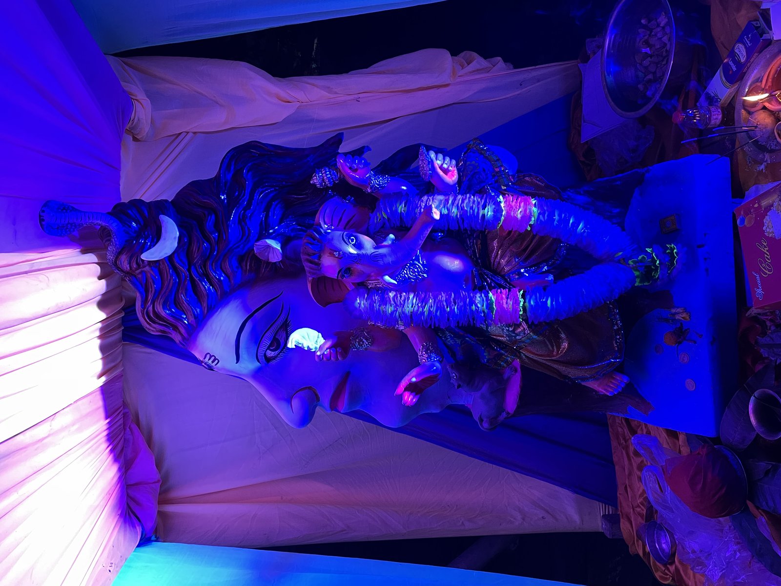 Decorated Lord Ganesha idol in a festival pandal